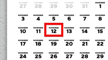 The date November 12th marked with a red cursor on the wall calendar 2025