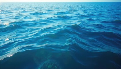 Vast expanse of deep blue ocean water, sunlit surface shimmering with subtle waves, tranquil scene of untouched marine environment , blue, aquatic life, background