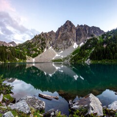 Mountain lake reflecting peaks, calm water, alpine scenery