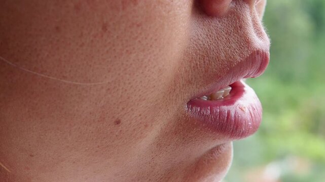 Close-up video of Asian woman&rsquo;s lips in motion while speaking, highlighting verbal expression and articulation. Ideal for ads on speech, communication, or language learning.