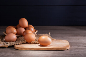 Fresh organic eggs from the farm are placed on a wooden table in the kitchen for preparing breakfast. Healthy food.