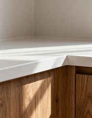 White countertop with wooden cabinets in sunlight
