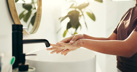 Basin, soap and washing hands with person in bathroom of home for morning routine or skincare....