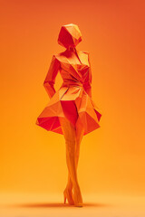 Stylized paper sculpture of a woman in a vibrant orange dress, showcasing modern design in a warm gradient background with artistic elements
