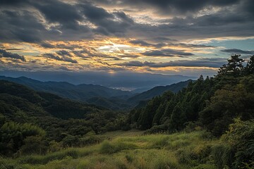Obraz premium Mountain vista at sunset, with lush greenery and dramatic clouds