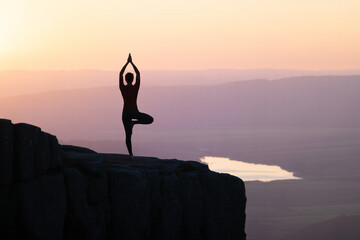 Meditative Silhouette of a Person Practicing Yoga at Sunset