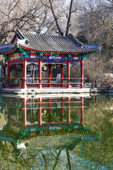 Traditional Chinese Pavilion Reflecting in a Serene Pond
