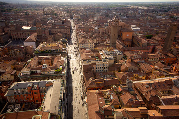 An expansive aerial view of a vibrant European city, showing a bustling central street lined with historic buildings and leading toward a distant horizon, ideal for city planning, travel, or urban pho © Bolucevschi