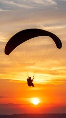 Silhouette paraglider sunset
