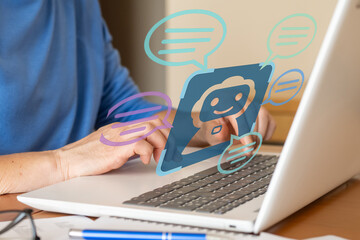 Office worker using a laptop interacting with an ai chatbot providing customer service, with speech bubbles symbolizing communication and assistance