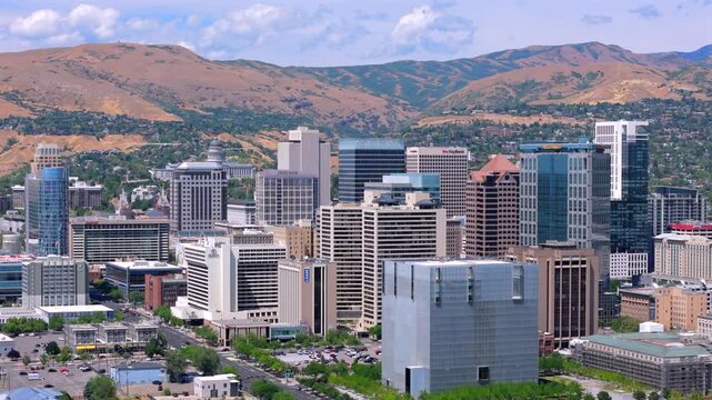 Stunning aerial shots that beautifully showcase the vibrant skyline of Salt Lake City, located in Utah, are set against picturesque and breathtaking mountainous backdrops that enhance the view