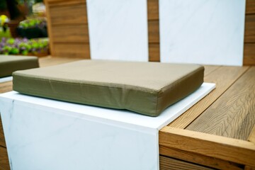soft polyurethane foam cushion with durable fabric cover lies on a stone bench for added seating...