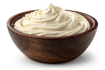 Cream cheese frosting in a dark wooden bowl isolated on white background