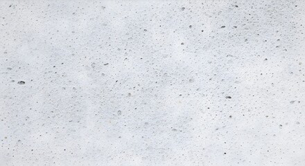 Obraz premium Close-up shot of a white, foamy surface with small bubbles and subtle variations in texture and tone.