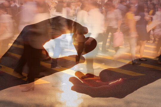 Man giving a heart to a woman. Love, friendship, kindness. Finding love and compassion in busy crowded city street background 