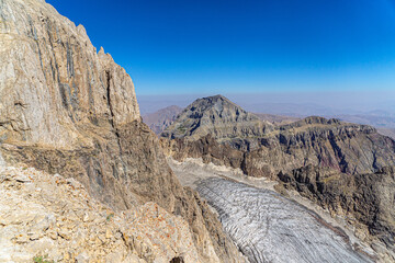 The scenic view of Reşko summit in the Sat (Cilo) mountains, Serpel and Horgedim plateau with its glaciers and glacier rivers in Hakkari, Turkey.