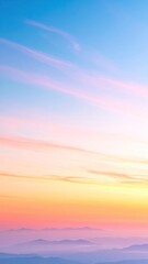 Obraz premium Breathtaking sunset paints the sky with vibrant hues of orange, yellow, pink, and blue over distant, blurred mountain peaks