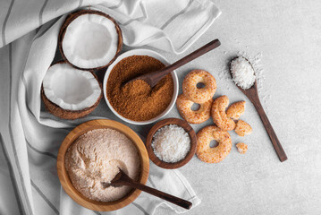 Organic coconut flour, coconut sugar, coconut flakes isolated on background, healthy gluten-free baking ingredient, natural tropical flour. 
