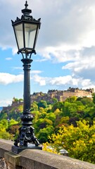 Fototapeta premium Black streetlamp overlooks Edinburgh Castle, autumn foliage