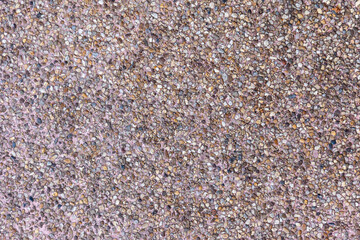 Macro closeup of a natural brown textured stone wall with rough sand and sea salt grain patterns