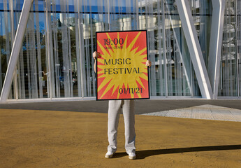 Mockup Of Man Holding Vertical Customized Framed Artwork Over Face