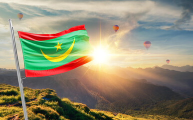 Mauritania flag waving in beautiful scenery. Mauritania national flag for independence day.