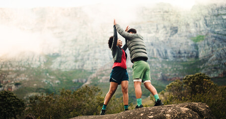 High five, hiking and couple with fitness, support and celebration with relationship. Space, man and woman with goals, challenge or trekking together with nature, travel or explore with achievement