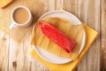 Sweet Tamale. hispanic dish typical of Mexico and some Latin American countries. Corn dough wrapped in corn leaves. The tamales are steamed. Usually accompanied with atole, hot chocolate or coffee