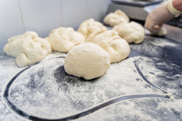 A heart shape is drawn in the flour on a counter