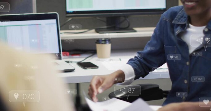 Recruiter wearing denim shirt sorting docs during job interview handing papers, closing handshake