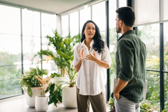 Happy young successful startup, business people of different human races chatting at office together