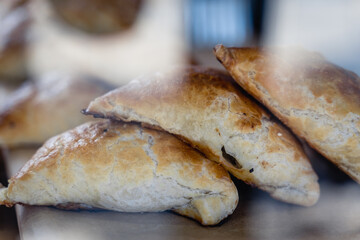 A tray of pastries with sesame seeds on top