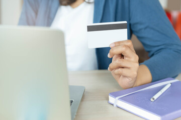 close up shots hands of person shopping on ecommerce and using credit card payment via online...