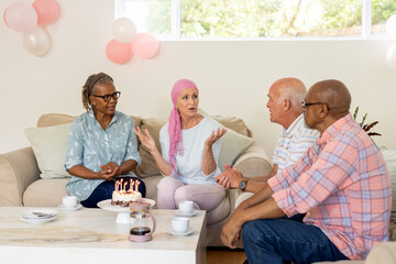 Celebrating birthday, senior friends with cake and coffee, having lively conversation