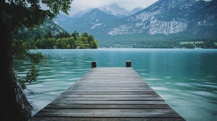 Obraz premium Serene lake vista, wooden dock leading to a tranquil mountain landscape