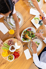 Sharing vibrant vegetarian meal with friends, enjoying fresh salads and appetizers