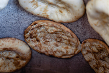 Uzbek flatbread whist on hay of tandoor and get ready. Cakes are ruddy and juicy, with appetizing crust