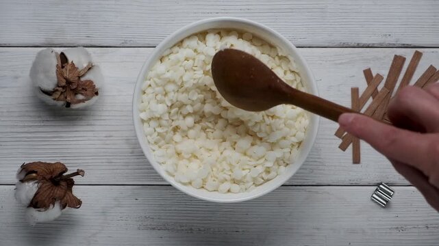 Granules of the soy wax in a bowl. Preparation for making candles. Candle making hobby.