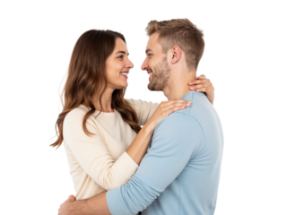 A man and a woman are smiling warmly at each other while embracing closely in a well-lit indoor setting. Their happiness is evident as they connect emotionally.