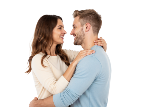 A man and a woman are smiling warmly at each other while embracing closely in a well-lit indoor setting. Their happiness is evident as they connect emotionally.