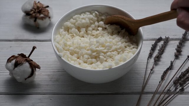 Granules of the soy wax in a bowl. Preparation for making candles. Candle making hobby.