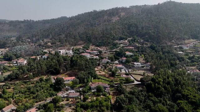 aerial view of hillside homes and forest in refojos de riba de ave portugal