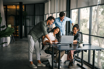 Busy smiling executive business team using digital devices in office. Diverse professional people