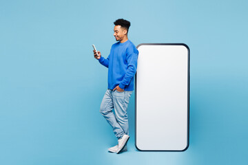 Full body side view young man of African American ethnicity in sweatshirt casual clothes stand near...