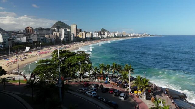 Aerial flyover tracks Leblon Beach from Mirante do Leblon toward Ipanema, Rio de Janeiro