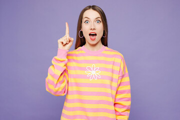 Young insighted smart proactive woman she wears yellow sweatshirt casual clothes holding index finger up with great new idea isolated on plain pastel light purple background studio. Lifestyle concept.