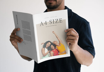 Mockup Of Man Reading Customizable A4 Magazine