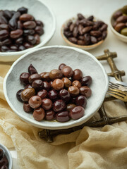 Various greek olives over a white background