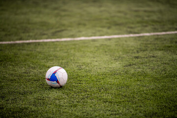 Soccer ball on green grass field. Sport and competition concept.
