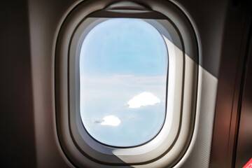 Looking out the window of an airplane at the blue sky and white clouds during flight isolated on transparent background